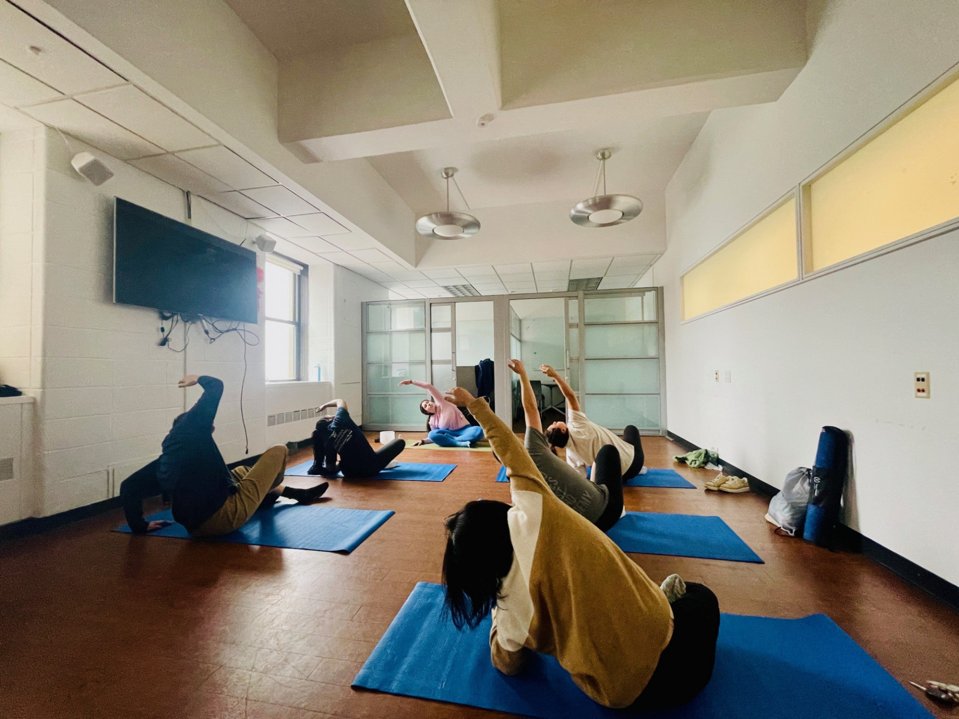 Columbia Engineering staff sitting on yoga mats stretching