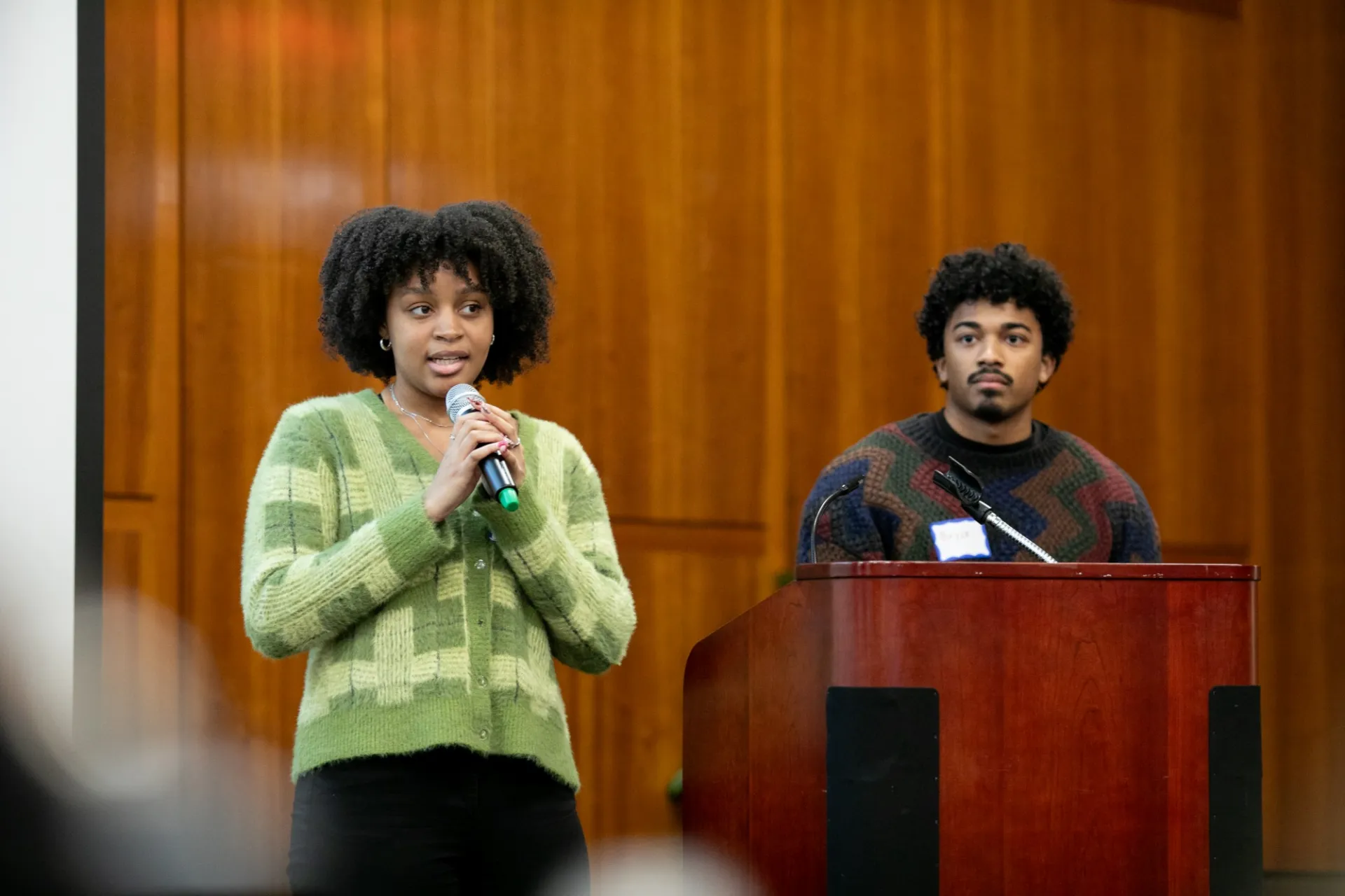 Two presenters addressing an audience.