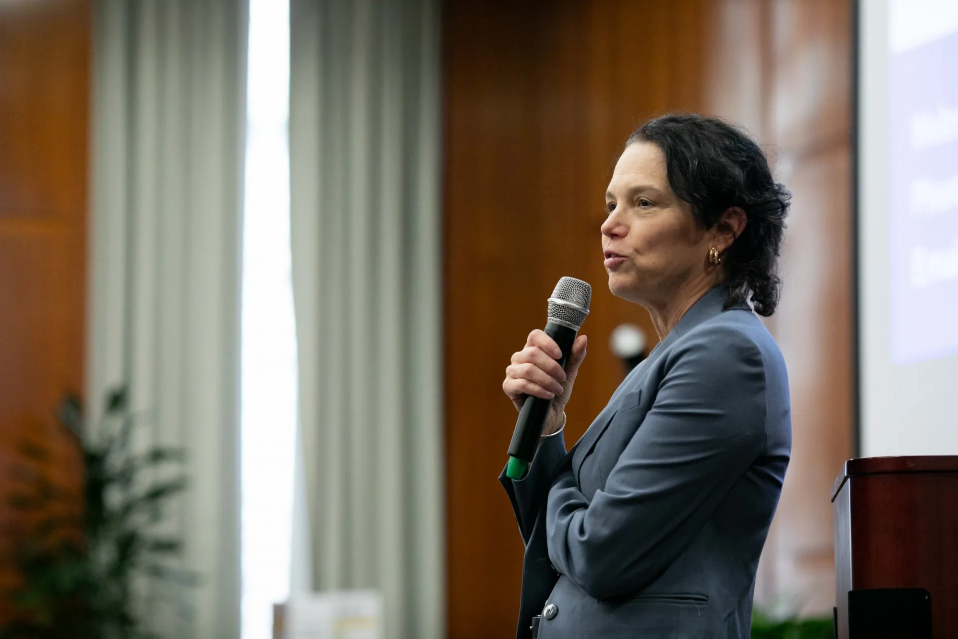 A presenter speaking into a microphone