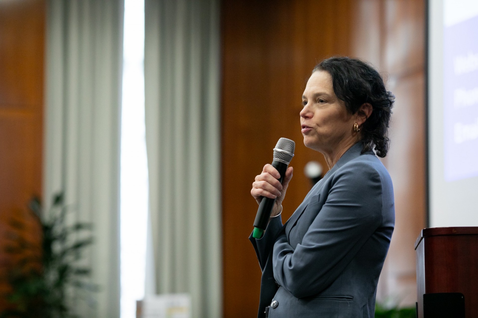 A presenter speaking into a microphone
