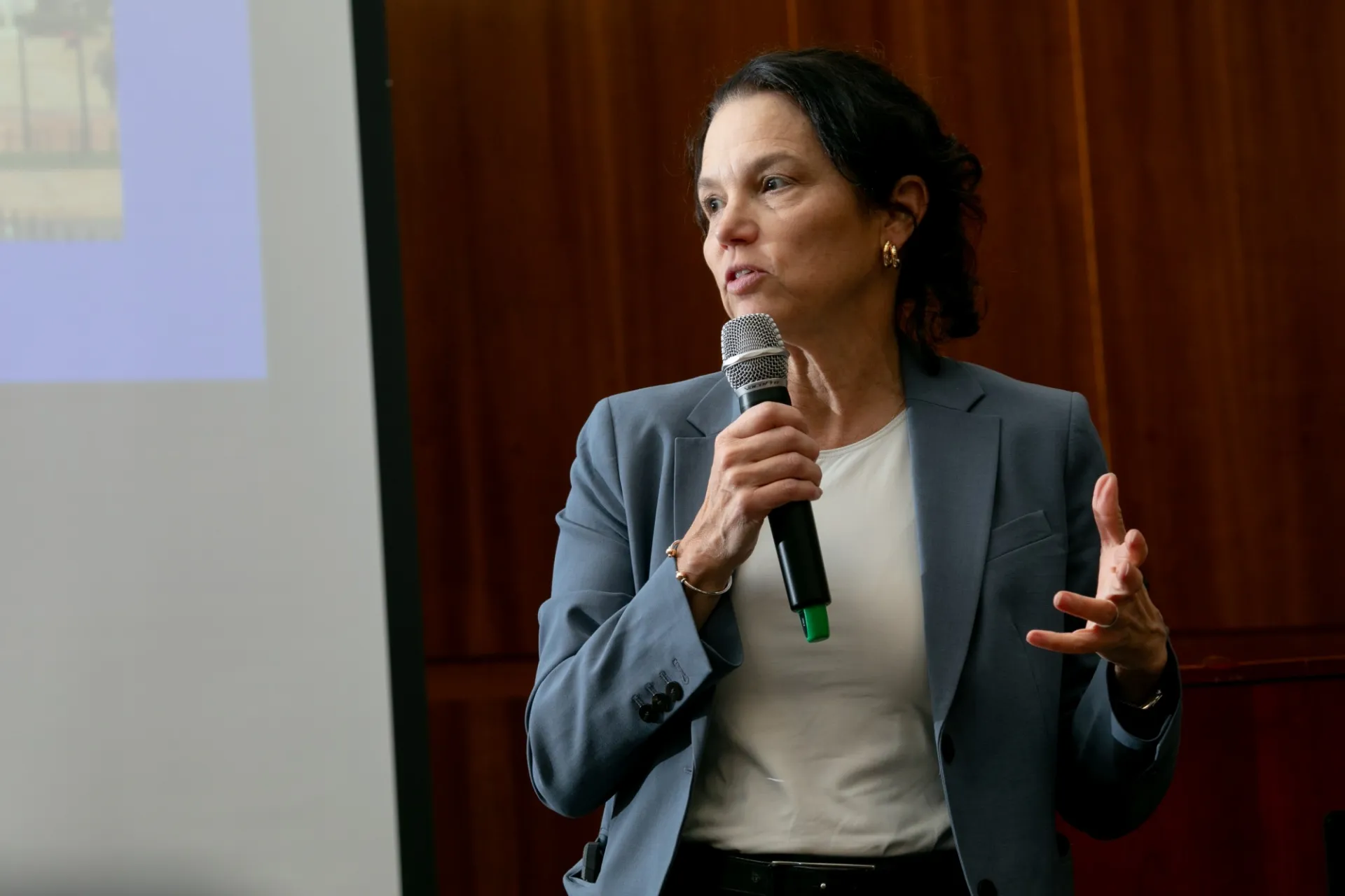 A presenter speaking into a microphone