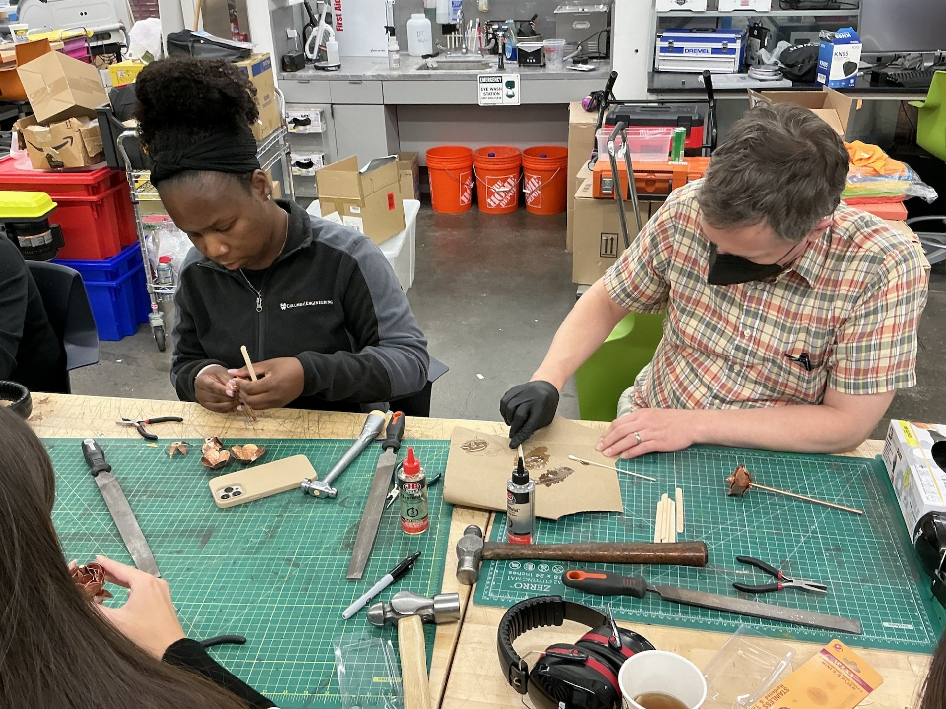 Two Columbia Engineering staff members focusing on their handiwork
