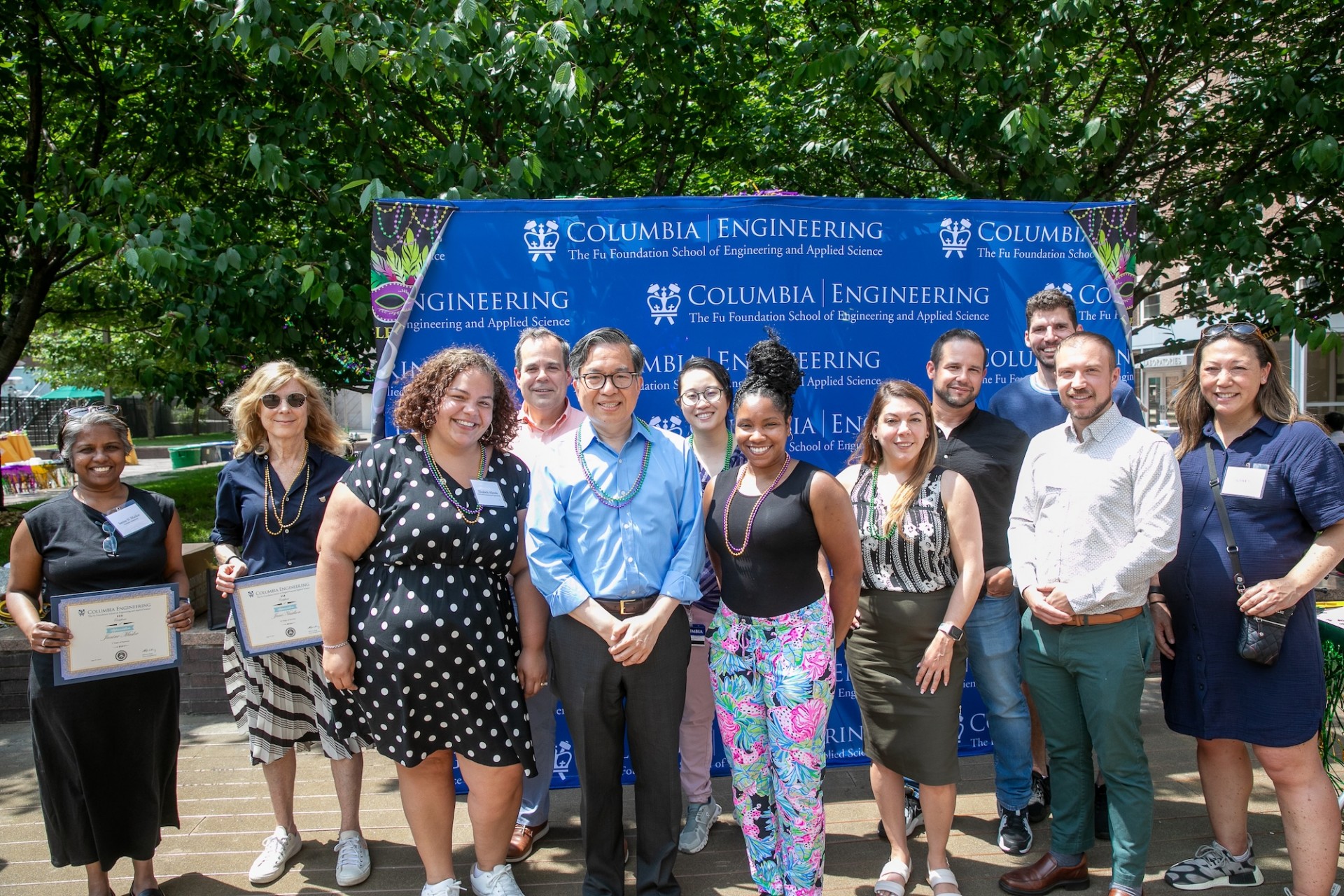 Columbia Engineering Dean Shih-Fu Chang posing with school staff holding certificates