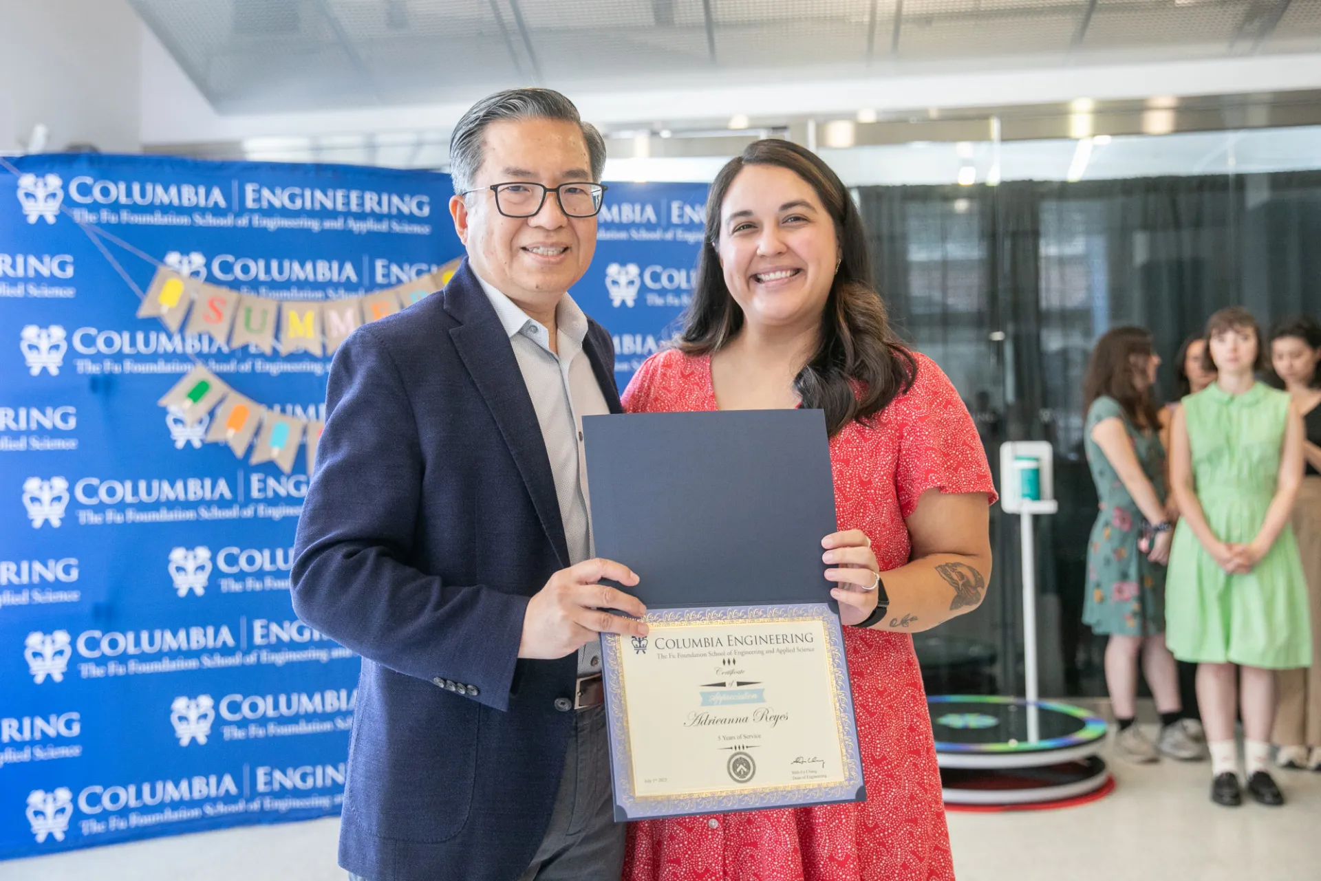 Dean giving certificate to staff member