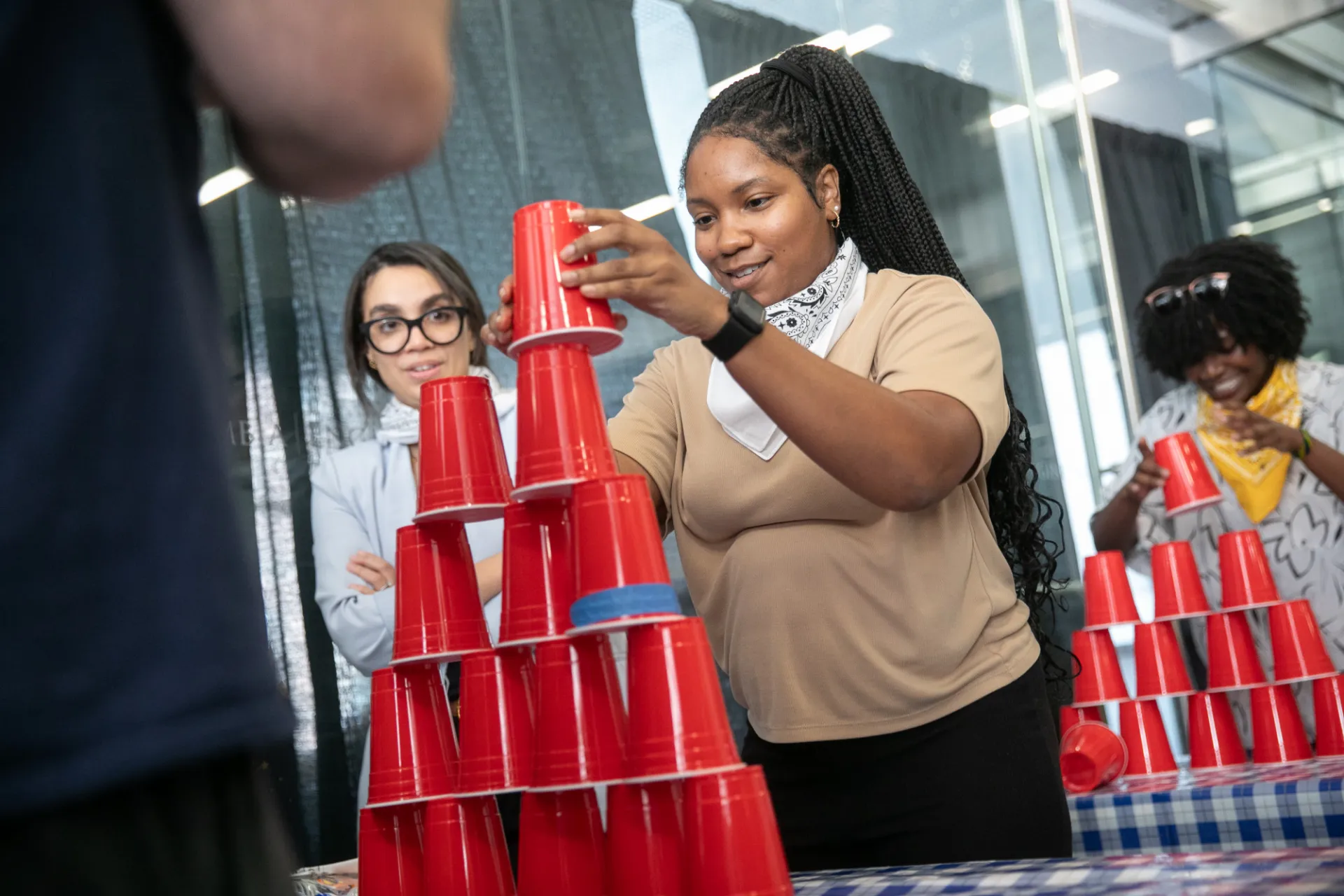 Staff member in white bandana stacking cups