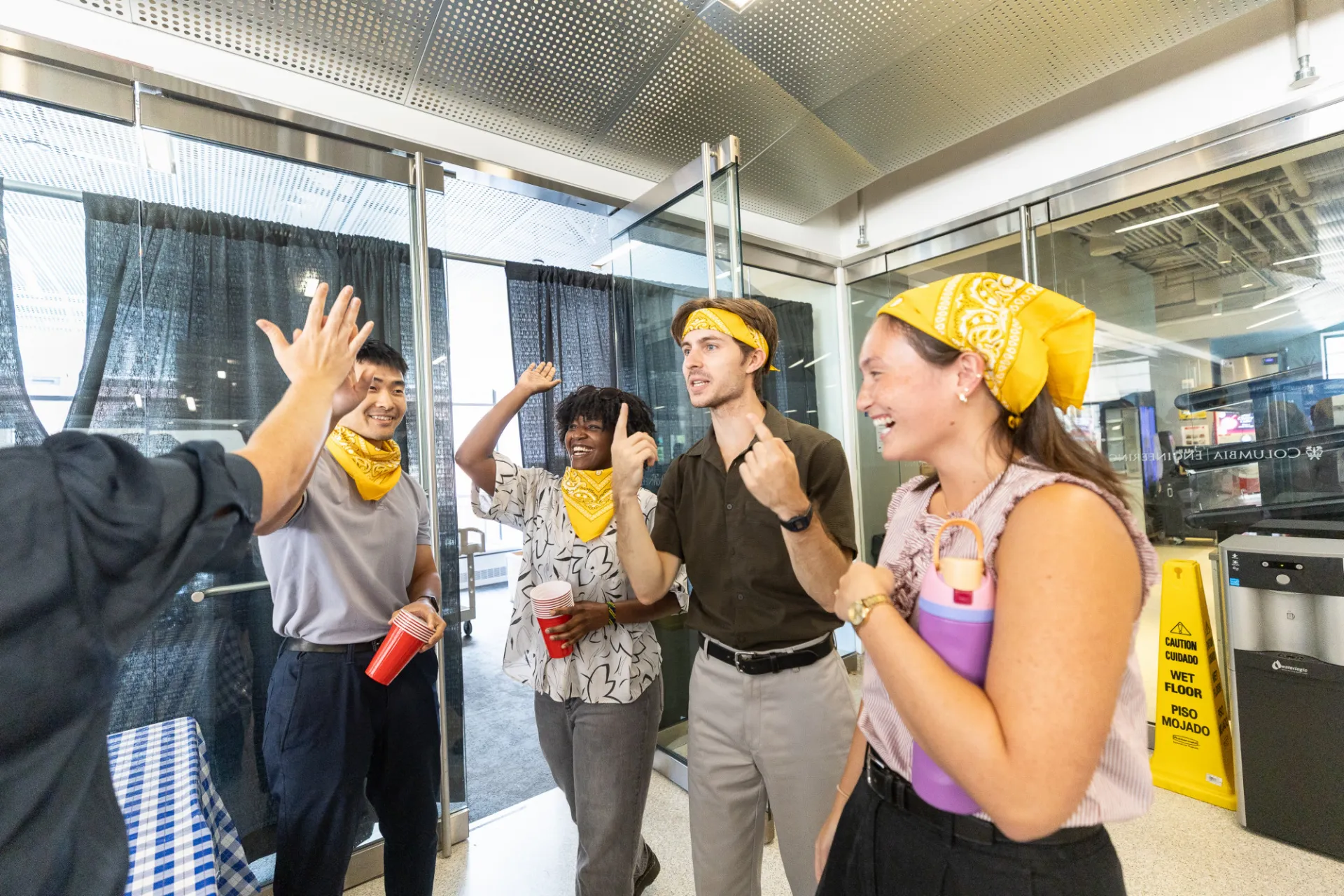 Staff members in yellow bandanas getting ready for friendly competition