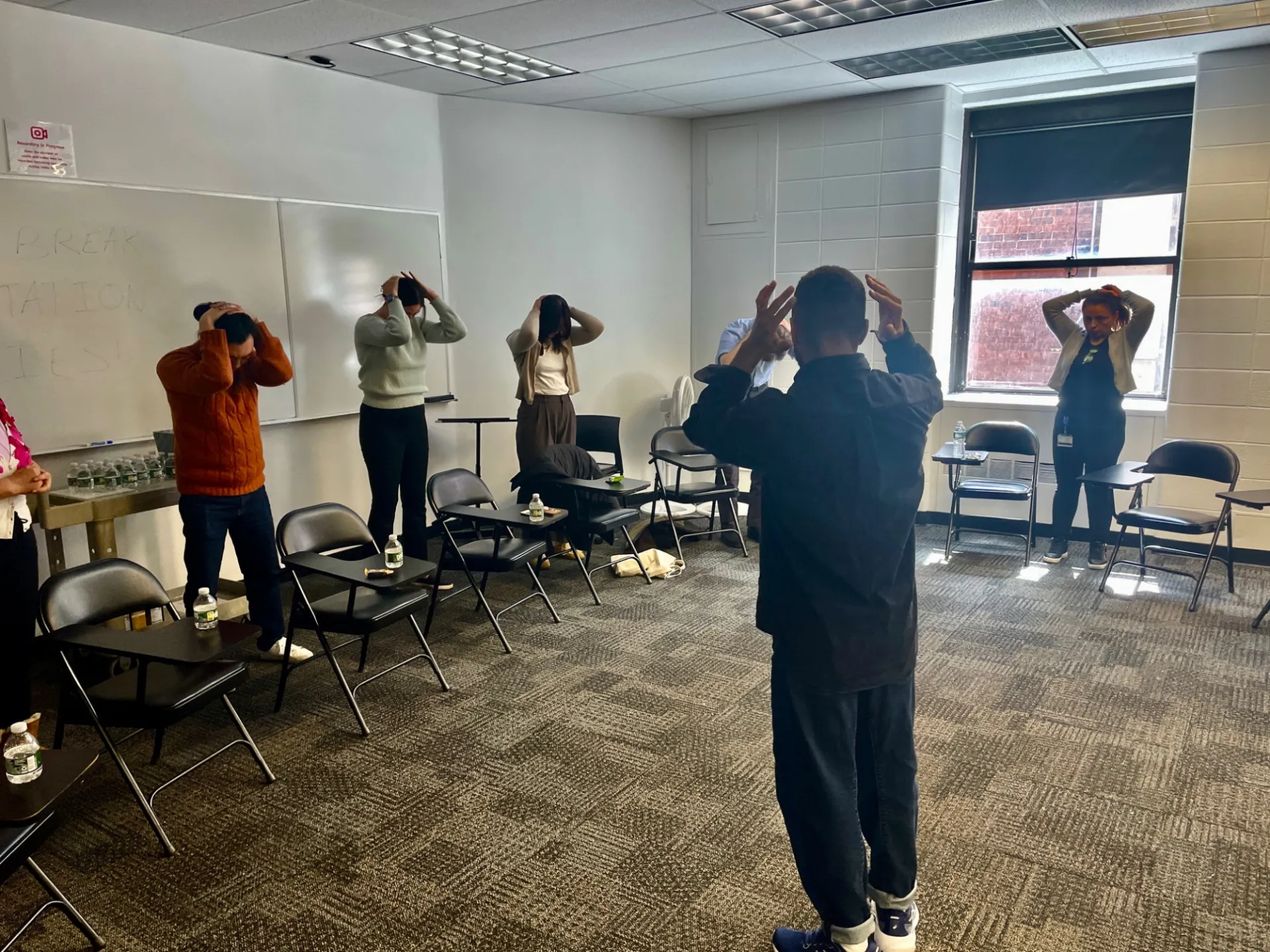 Staff engaging in a neck stretch pose 