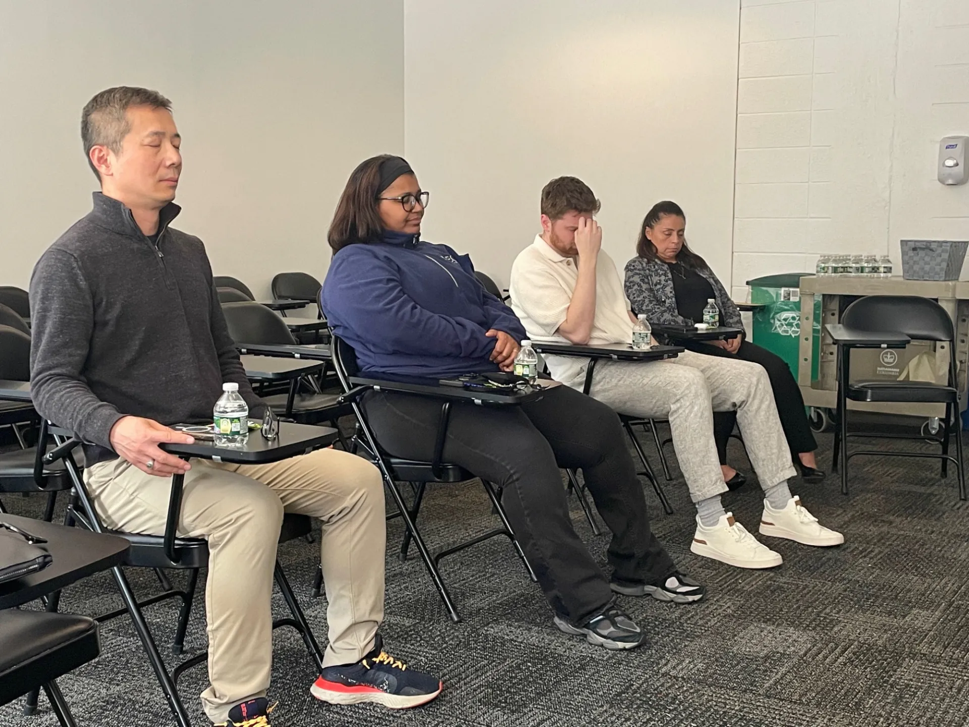 Staff meditating at their desk
