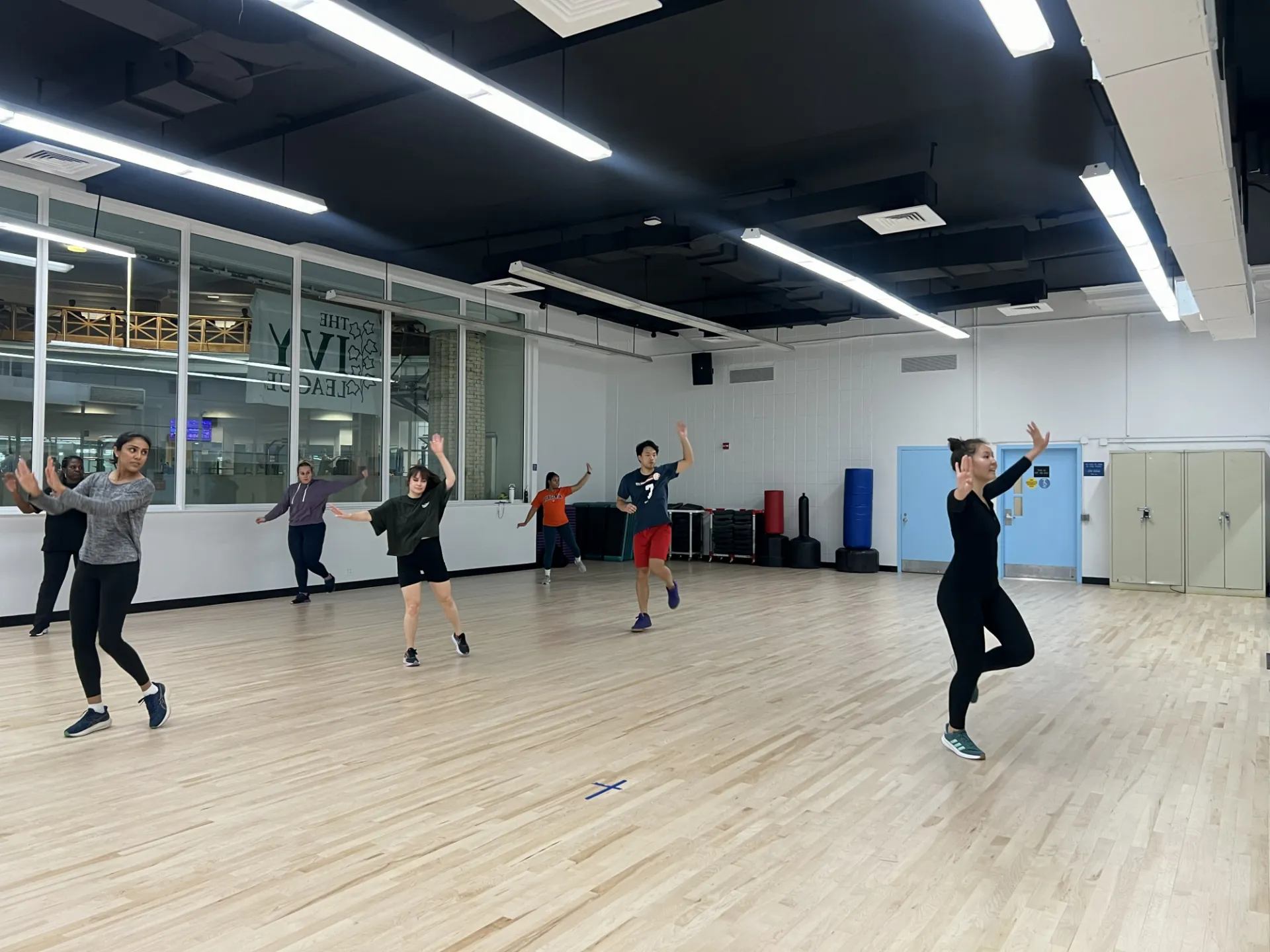 Several staff dancing funny following an instructor 