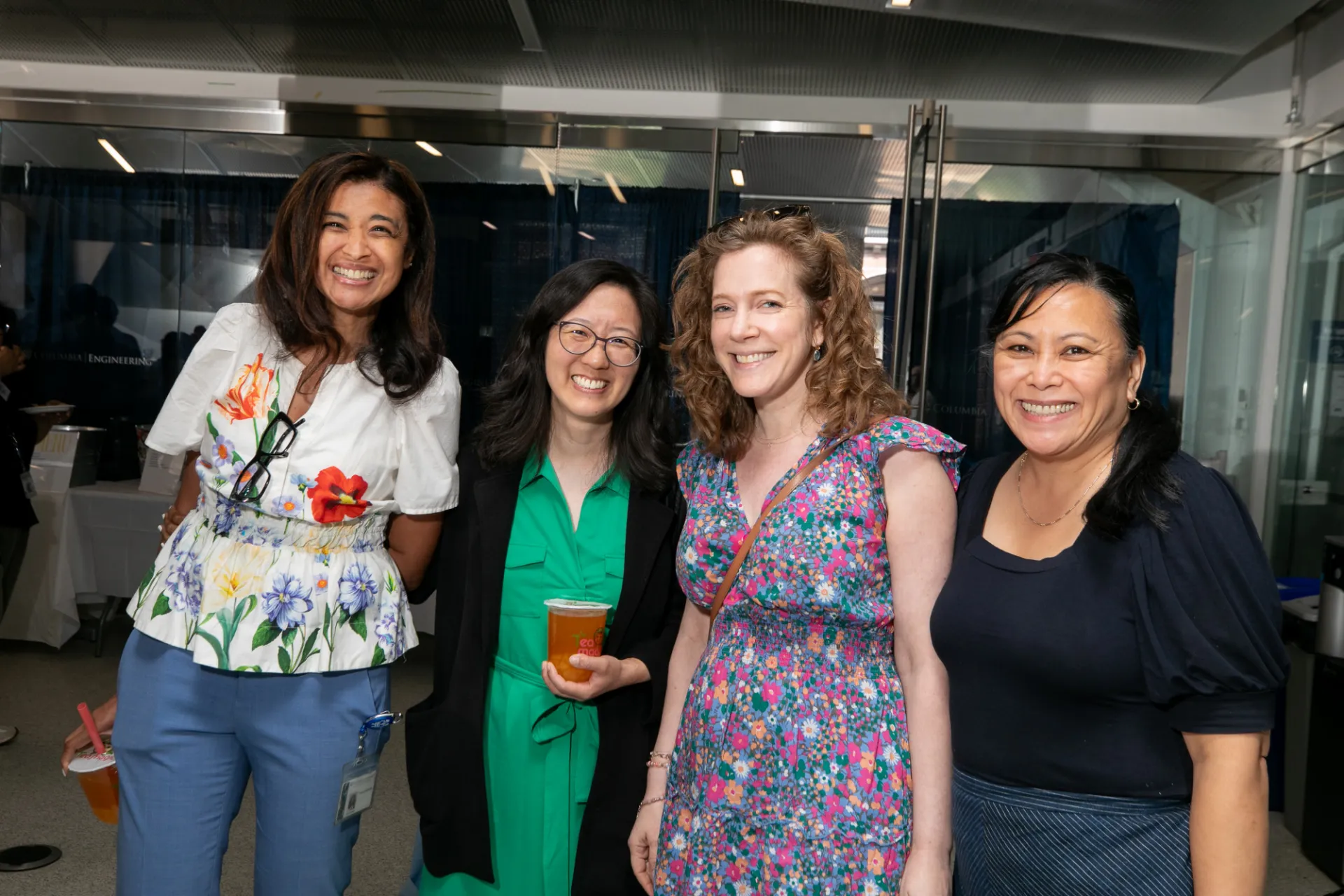 Four staff smiling with boba tea