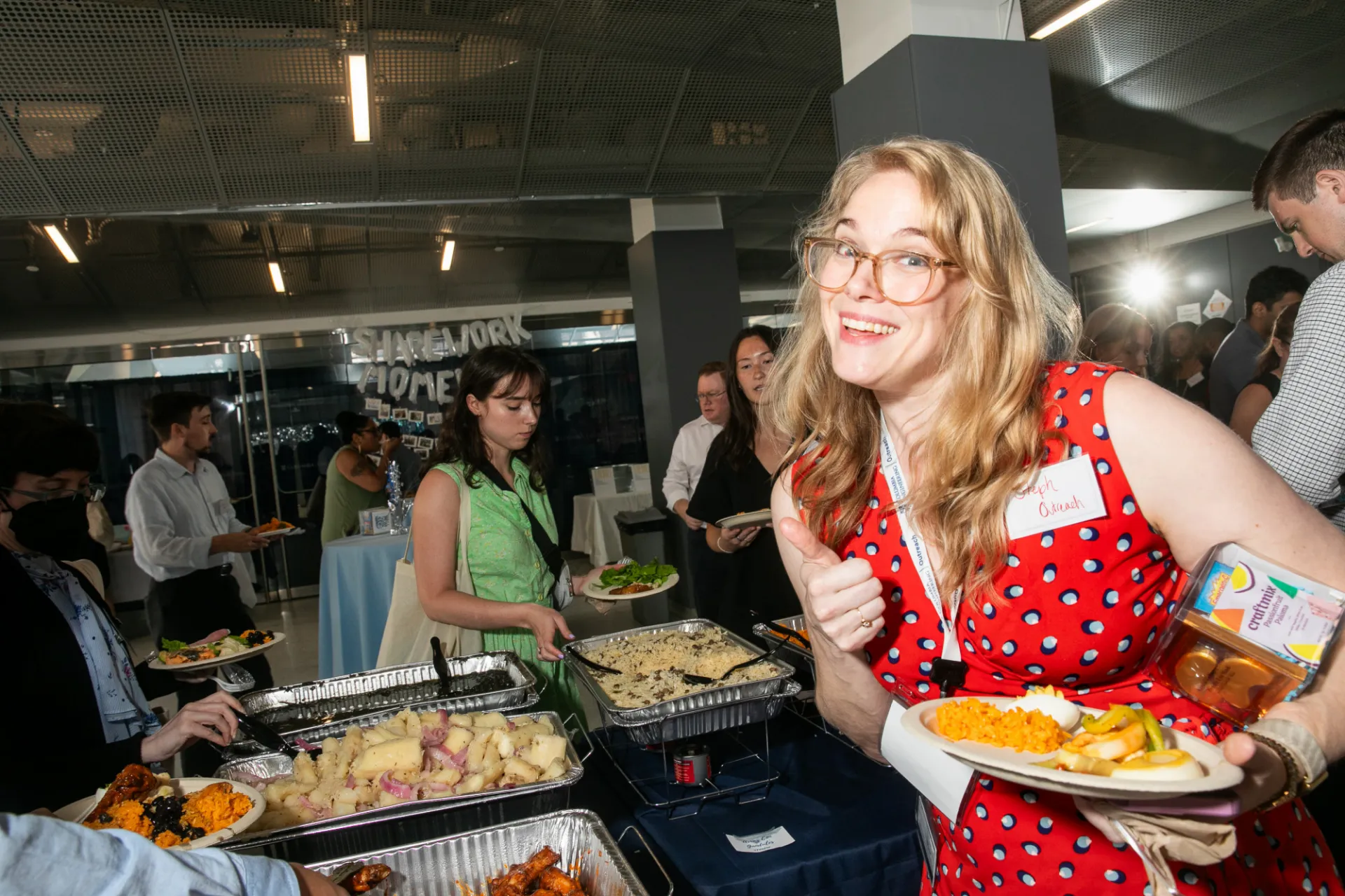 Staff member giving thumbs up at a buffet