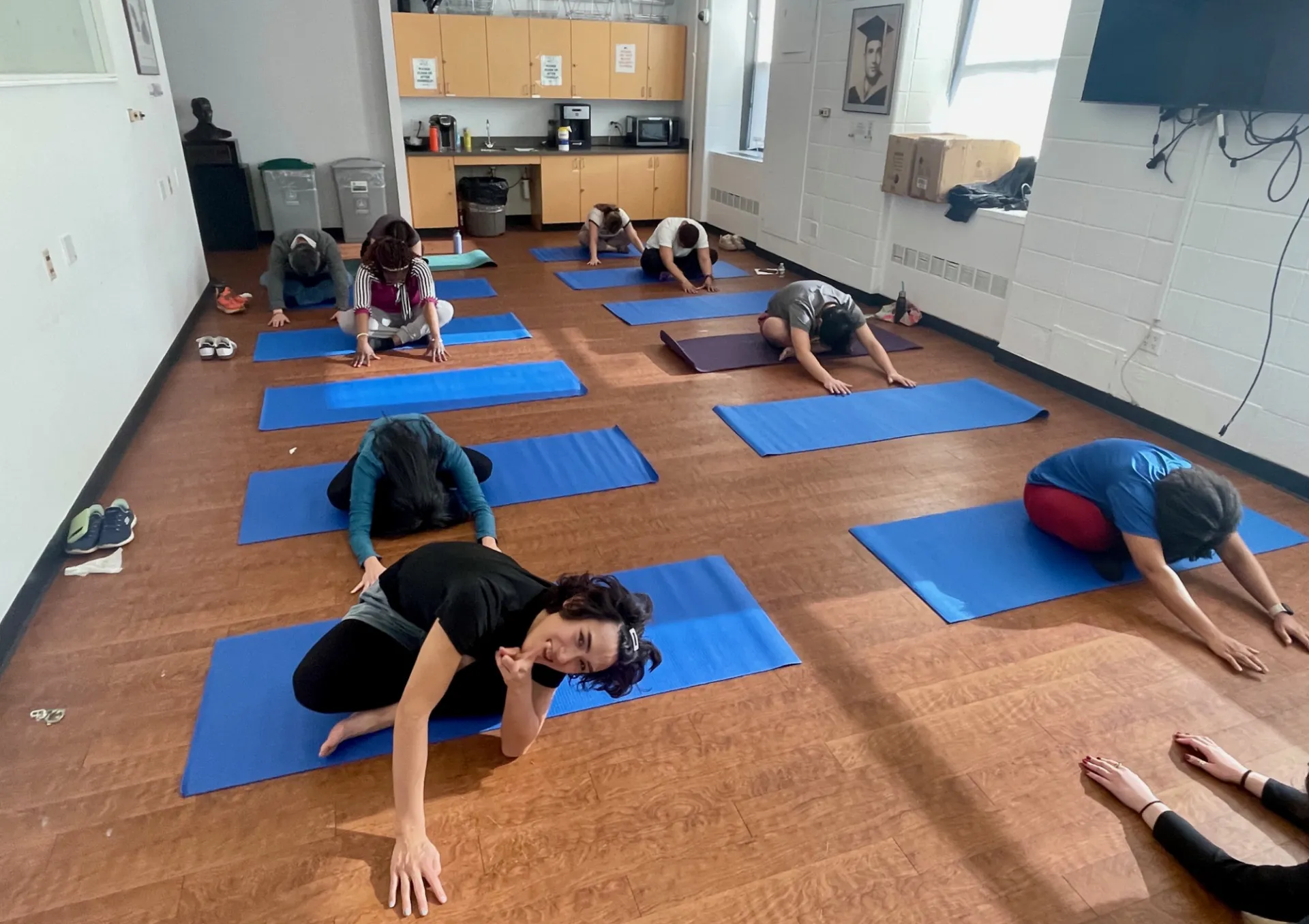 Staff sitting and reaching forward doing yoga