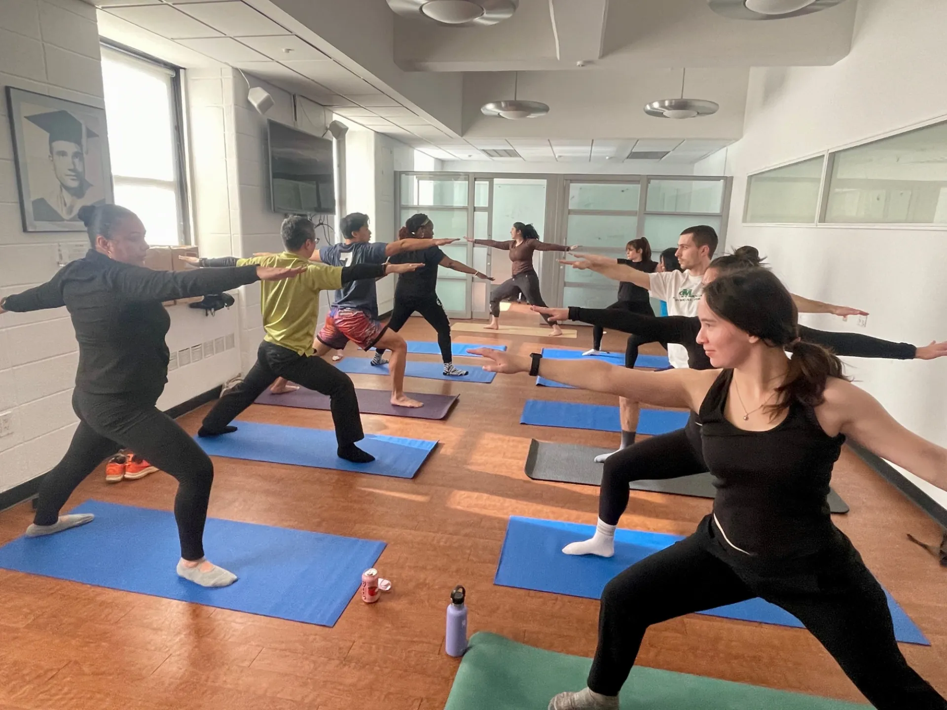 Several staff doing a warrior pose for yoga