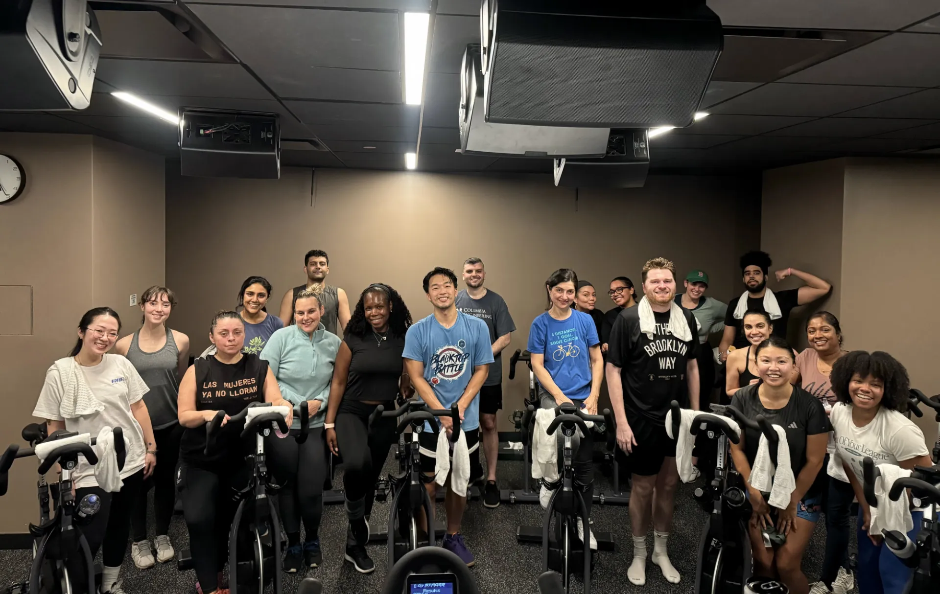 Columbia engineering staff gathering for a group photo on gym cycles