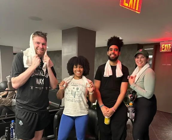 Staff smiling with towels after a workout
