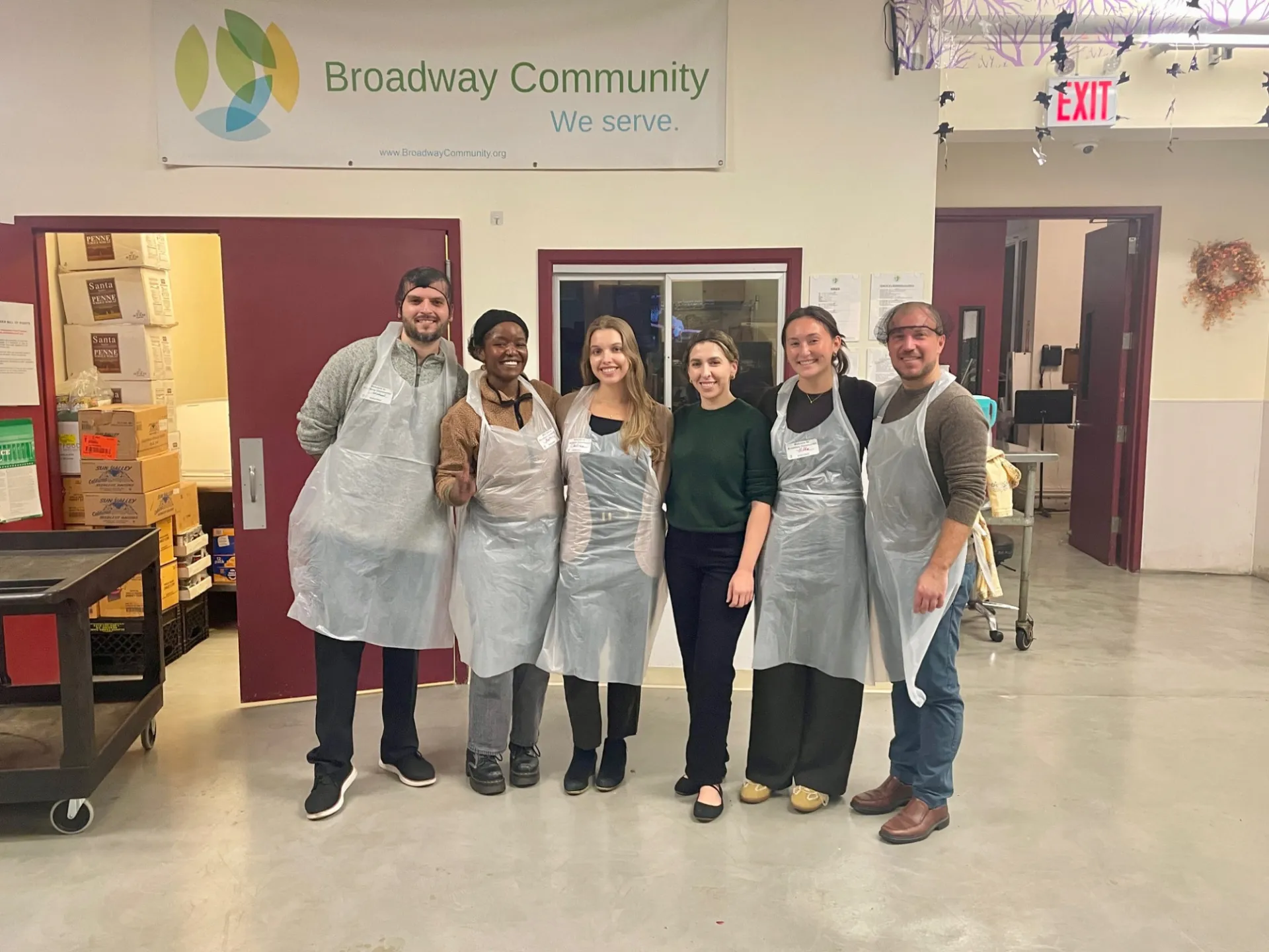 Columbia engineering staff posing for picture with Broadway community backdrop 